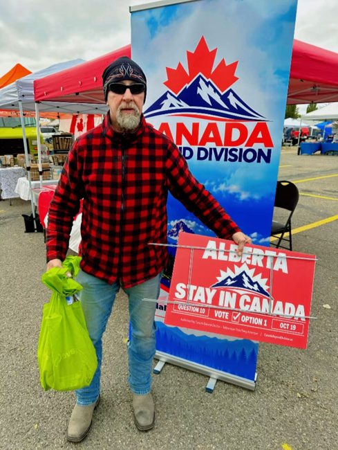Community member with a lawn sign