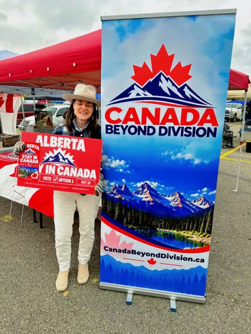 Supporter beside the Canada Beyond Division banner