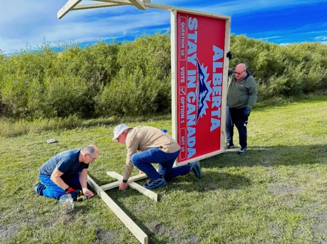 Volunteers assembling a roadside billboard frame