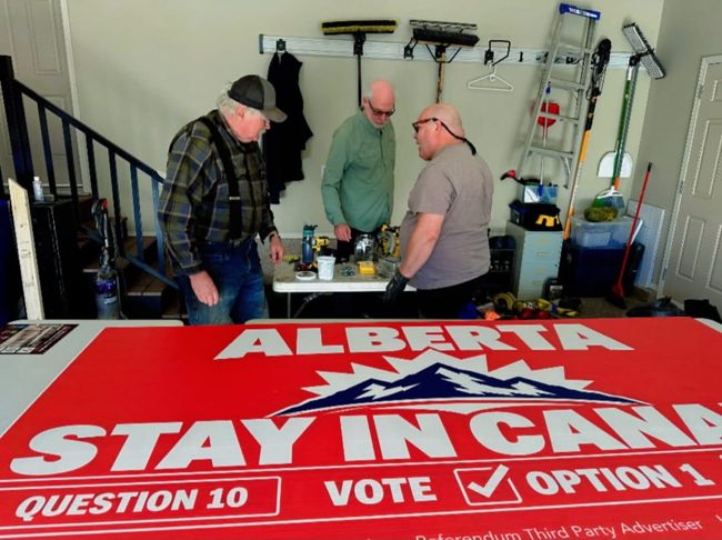 Volunteers preparing a large billboard