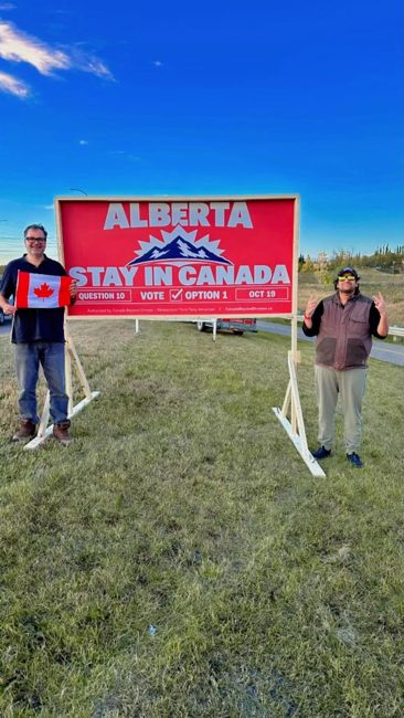 Volunteers beside their billboard installation