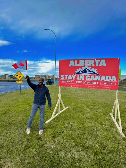 Volunteer with a completed roadside billboard