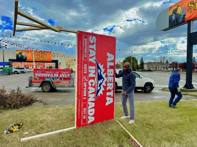 Volunteers working on a billboard installation