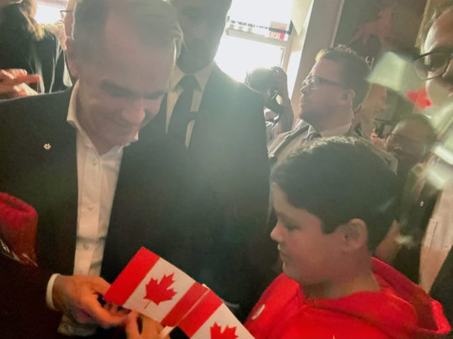 A special moment with a young attendee and Canadian flag