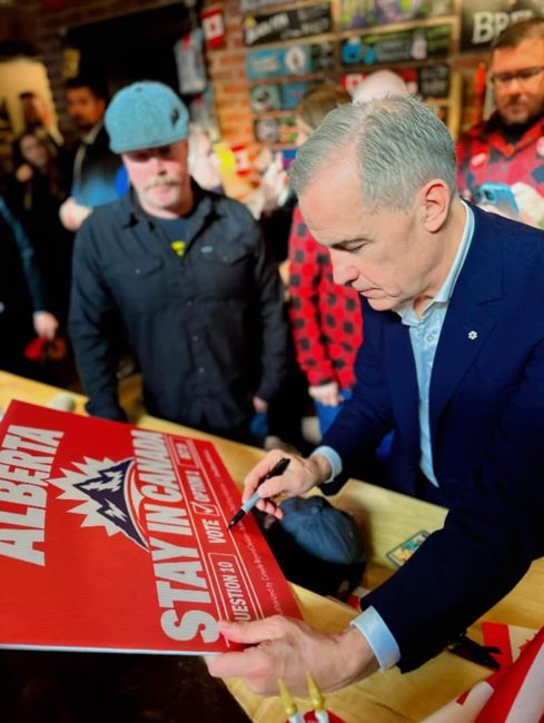Signing a Stay in Canada campaign sign