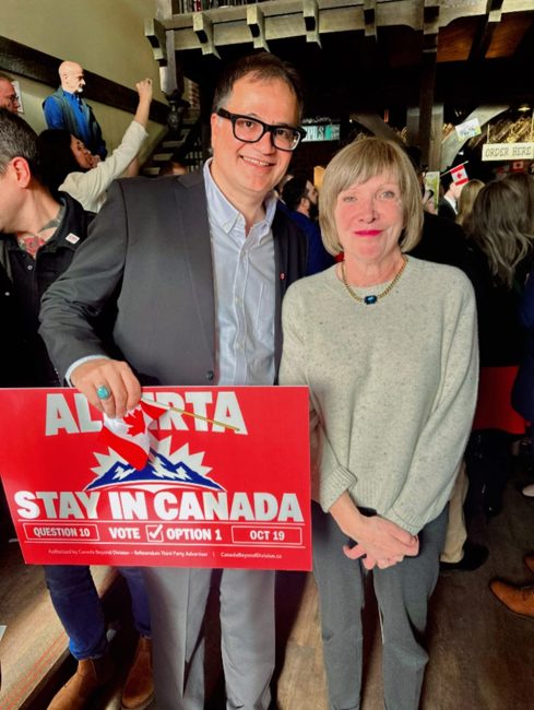 Community members holding a Stay in Canada sign