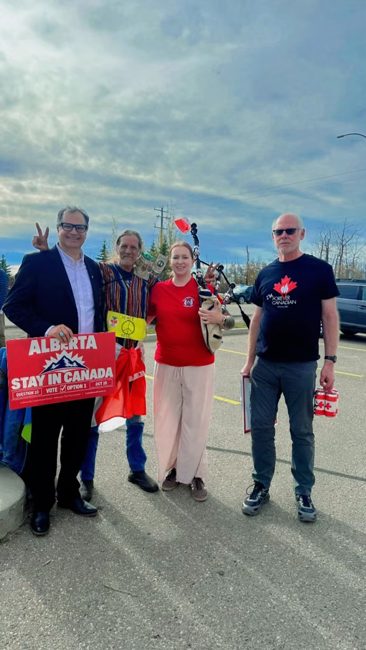 Supporters together holding a Stay in Canada sign